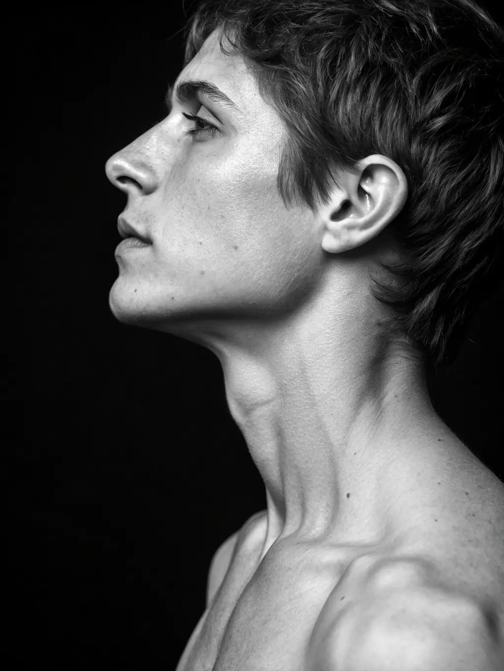 A side view of a patient’s neck and shoulders showing relaxed trapezius area, in black and white, minimalist style.